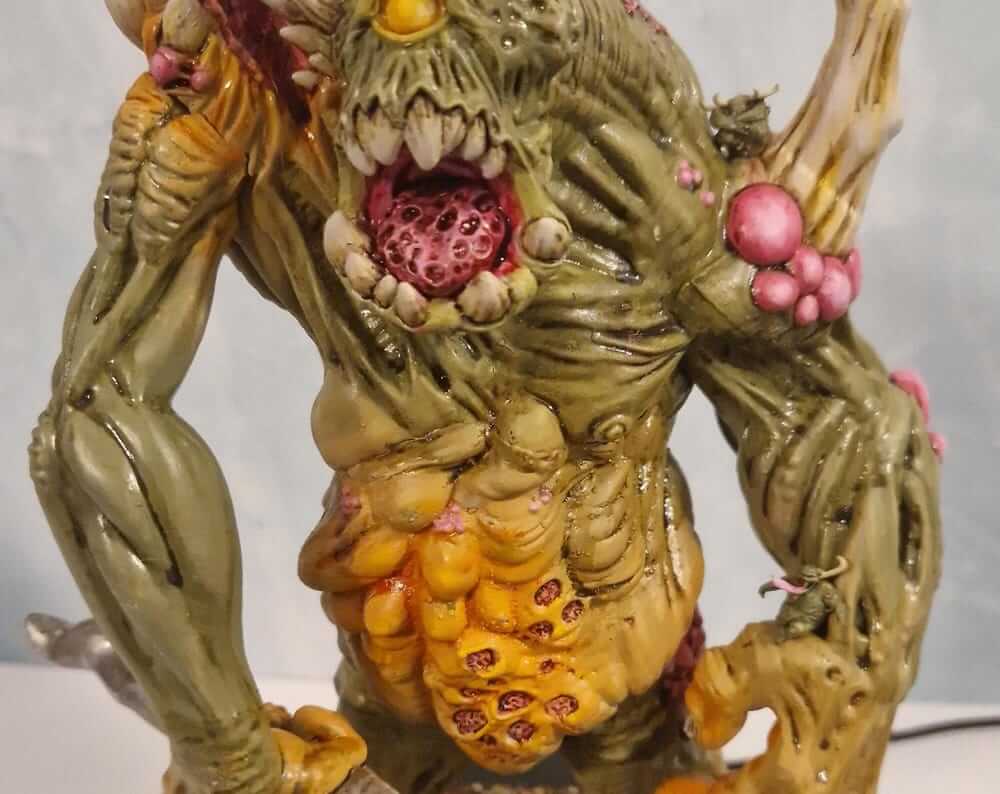 Detailed painted miniature depicting a monstrous creature with vibrant colors and intricate textures.